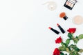 Set classic makeup with red lipstick, beige powder, string of pearls and bouquet of rose flowers