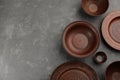 Set of clay dishes on grey table, flat lay. Space for text Royalty Free Stock Photo