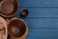 Set of clay utensils on blue wooden table  flat lay. Space for text Royalty Free Stock Photo