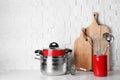 Set of clean cookware and utensils on table against white wall Royalty Free Stock Photo