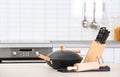 Set of clean cookware and utensils on table in kitchen Royalty Free Stock Photo