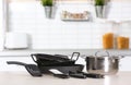 Set of clean cookware and utensils on table in kitchen. Royalty Free Stock Photo