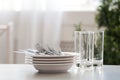 Set of clean dishes, cutlery and glasses on table indoors. Space for text Royalty Free Stock Photo