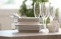 Set of clean dishware, cutlery and champagne glasses on table indoors Royalty Free Stock Photo