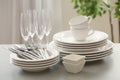 Set of clean dishware, cutlery and champagne glasses on table indoors Royalty Free Stock Photo