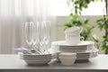 Set of clean dishware, cutlery and champagne glasses on table indoors Royalty Free Stock Photo
