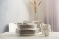 Set of clean dishware and cutlery on white table indoors. Space for text Royalty Free Stock Photo