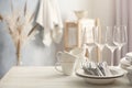 Set of clean dishware, cutlery and wineglasses on white table indoors. Space for text Royalty Free Stock Photo