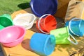 Set of clean multi-colored plastic buckets, outdoor, on a Sunny summer day in the garden Royalty Free Stock Photo