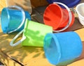 Set of clean multi-colored plastic buckets, outdoor, on a Sunny summer day in the garden Royalty Free Stock Photo