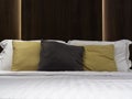 Set of clean pillows, brown, yellow and white, blanket and bed sheet in the hotel room. Royalty Free Stock Photo