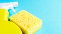 Set of cleaning products on a blue background. Yellow rag and sponge, cleaning spray, detergent. House cleaning concept