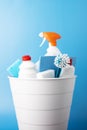 Set of cleaning products for cleaning and disinfection in a bucket on a blue background Royalty Free Stock Photo