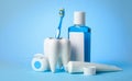 Set for cleaning teeth and mouth. Toothpaste, toothbrush, dental floss and mouthwash on a blue background Royalty Free Stock Photo