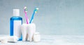 Set for cleaning teeth and mouth. Toothpaste, toothbrush, dental floss and mouthwash on a gray background Royalty Free Stock Photo