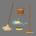 Set of cleaning tools. Floor brush with a wooden handle, mop, an old bucket full of water and soap in a puddle with bubbles.