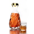 A set of clear bottles and elegant glasses for holding alcoholic beverages such as brandy and whiskey. Clear half glass liqueur