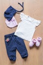 Set of clothes and objects for the child on a wooden background: pants, hats, beacon Royalty Free Stock Photo