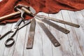 Set of cobbler tools on the light wooden background. Space for t