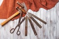 Set of cobbler tools on the light wooden background. Space for t