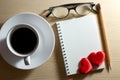 Set of coffee cups, glasses, pencils, and two red hearts on notebook space for your greeting, flat lay, Valentine\'s day Royalty Free Stock Photo