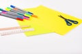 Set of color papers, scissors, ruler, felt-tip pens and pencil for creative work on white background. Top view. Flatlay