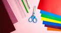 Set of color papers, scissors, ruler, pen and pencil for Valentine`s day card crafts on pink background. Top view. Flatlay.