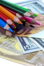 A set of color pencils and money.A School stuff.Drawing supplies