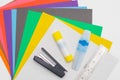 Set of colored cardboard for cutting. Stapler, glue stick, colored markers and ruler Royalty Free Stock Photo