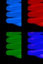 Set of colored CFL neon light bulbs on black background Royalty Free Stock Photo