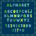 Set of colored letters and numbers. Childrens alphabet. Font for kids. Bright colors, blue, green, yellow on blue background. Royalty Free Stock Photo