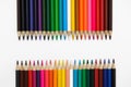 Set of colored pencils arranged in a two rows horizontally opposite each other on a white background Royalty Free Stock Photo