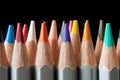 Set of colored pencils on a black background. Sharpened colored pencils. Royalty Free Stock Photo