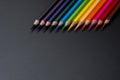 Set of colored pencils, row of wooden colored pencils on black background. colored pencils for drawing, colorful, copy space. Royalty Free Stock Photo