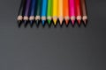 Set of colored pencils, row of wooden colored pencils on black background. colored pencils for drawing, colorful, copy space. Royalty Free Stock Photo