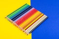 Set of colored pencils for schoolboy on bright background