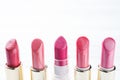 Set of colored pink lipsticks on white background. Women`s cosmetics. Selective focus. Copy space Royalty Free Stock Photo