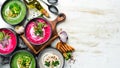 Set of colored soups on white wooden background. Beet soup, broccoli cream soup and mushroom soup. Royalty Free Stock Photo