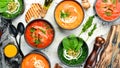 Set of colored tasty soups on white wooden background. Spinach, tomato and carrot soup. Royalty Free Stock Photo