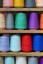 Multi-colored large spools of thread in a row. Spools of colored thread Royalty Free Stock Photo