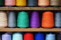 Multi-colored large spools of thread in a row. Spools of colored thread Royalty Free Stock Photo