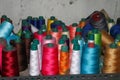 Set of colored threads for sewing on coils. Pile of big colorful spools of thread. Colored thread spools of thread large Royalty Free Stock Photo