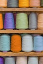 Multi-colored large spools of thread in a row. Spools of colored thread Royalty Free Stock Photo