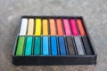 Set Of Colorful Chalk Stick On Black Tray Background