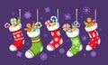 Set Colorful Christmas Socks with Sweets Isolated on Purple Background with Snowflakes. Winter Collection of Stockings Royalty Free Stock Photo