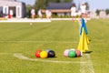 A set of colored croquet balls on the green lawn before the game