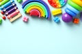 Set of colorful educational toddler toys on pastel blue background. Xylophone, montessori, building blocks construction, pop. Flat Royalty Free Stock Photo