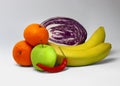 Set of colorful fruts on white. Banans, cabbage, mandarins, apple, hot pepper Royalty Free Stock Photo