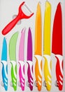 Set of colorful kitchen knives for various uses and a red peeler Royalty Free Stock Photo