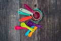 Set of colorful measuring cups and measuring spoons use in cooking lay on wood tabletop in top view Royalty Free Stock Photo